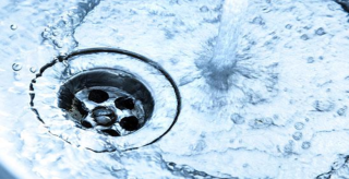 Image of water flowing down a drain