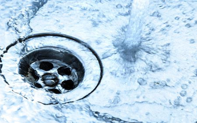 Image of water flowing down a drain